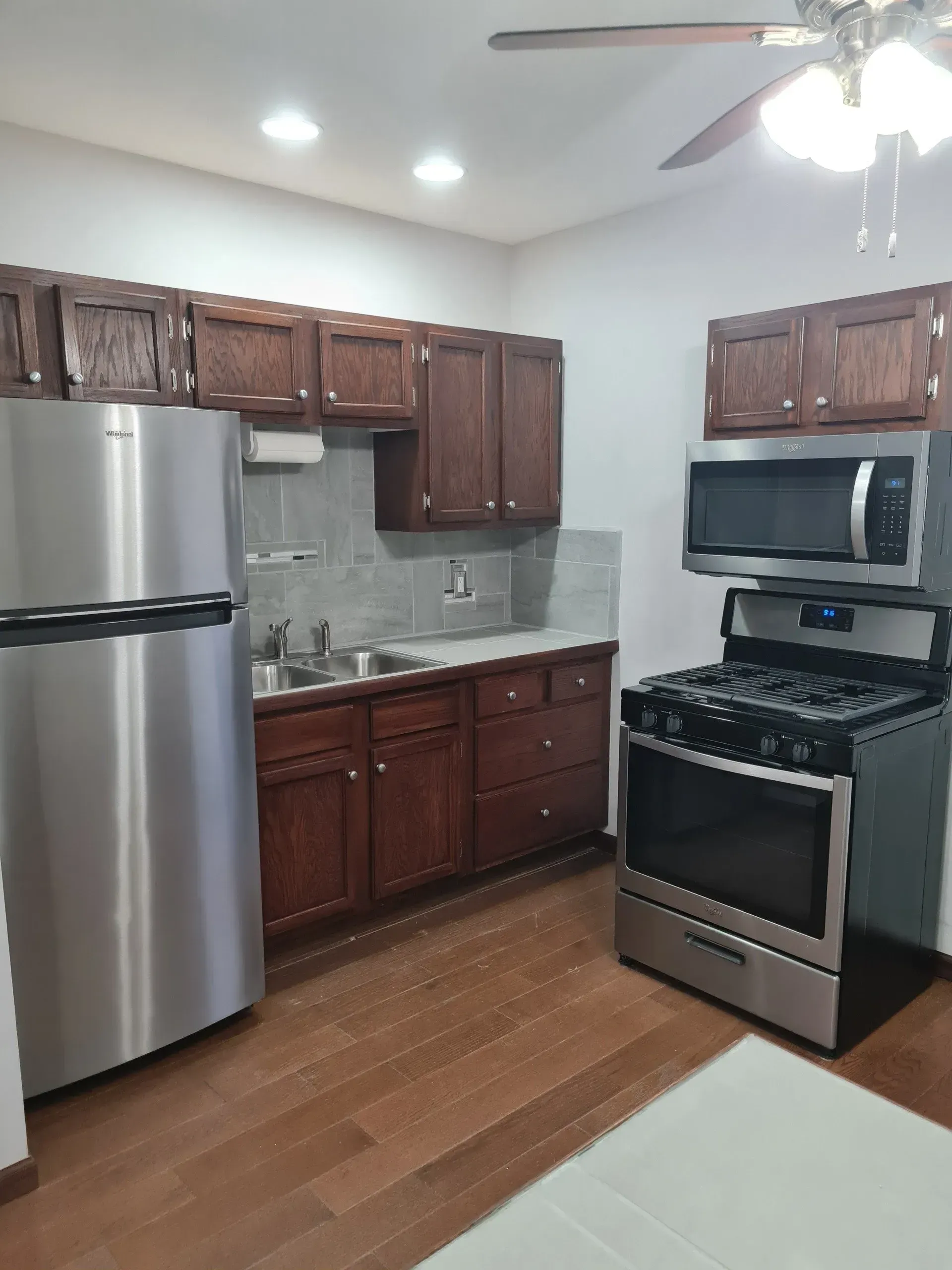 A kitchen with stainless steel appliances and wooden cabinets