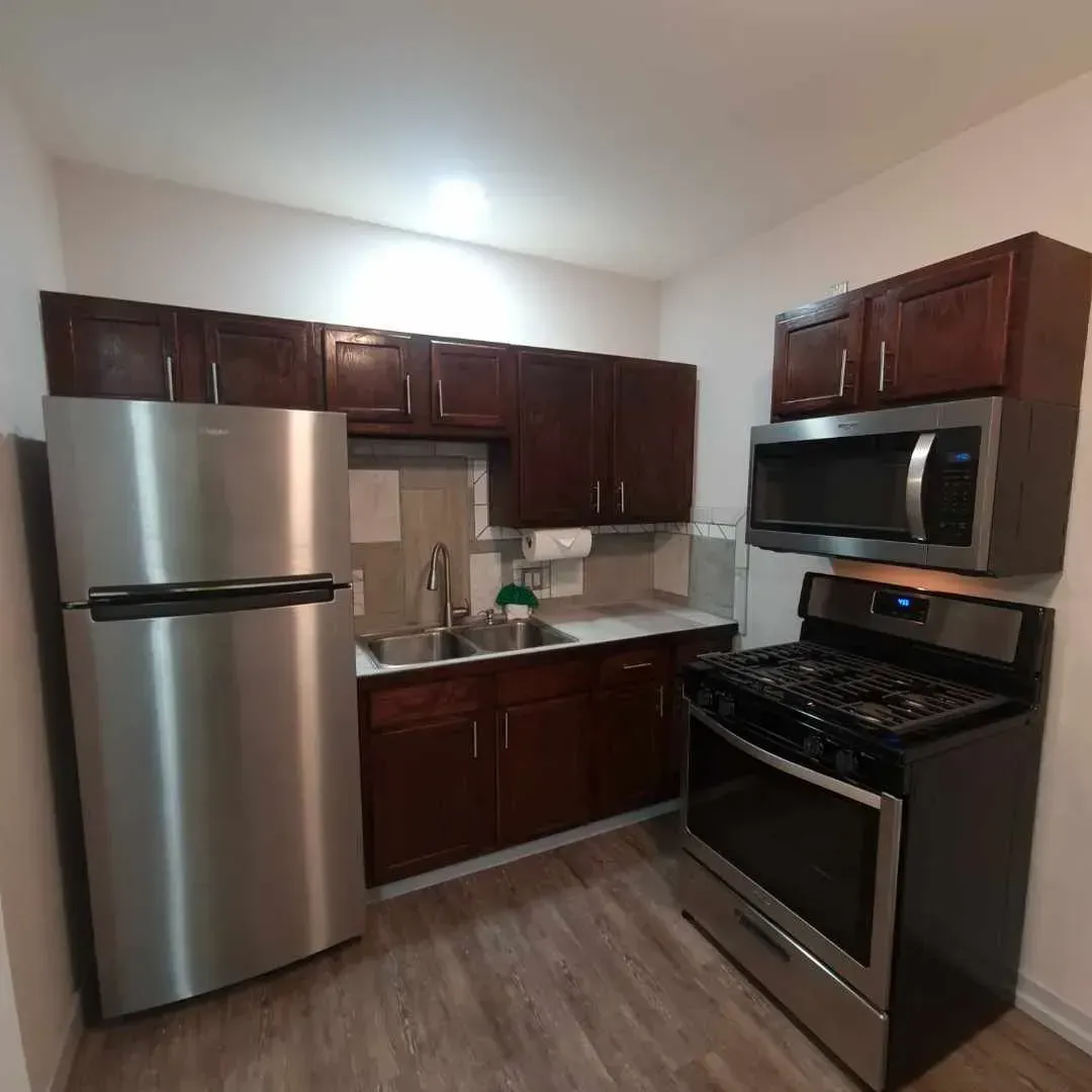A kitchen with stainless steel appliances and wooden cabinets