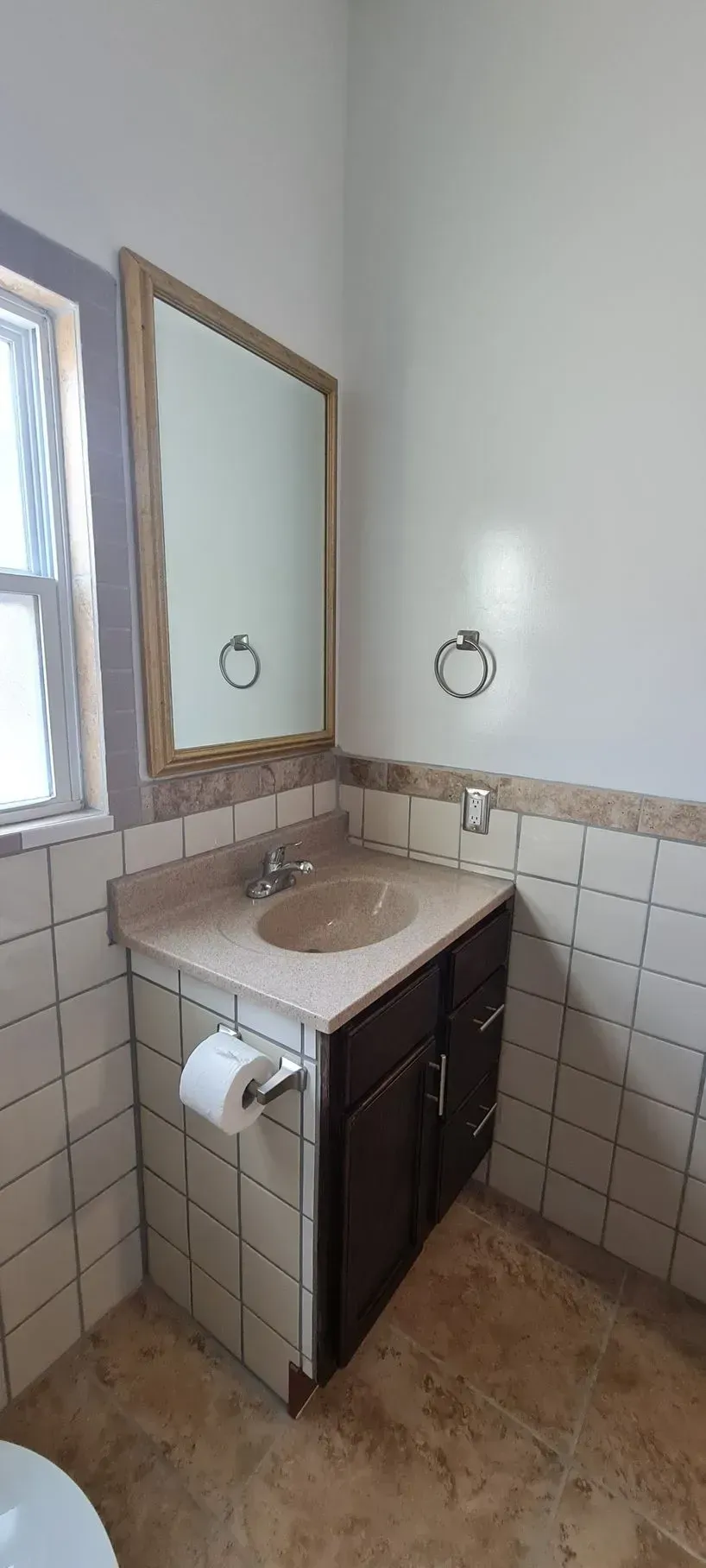 A bathroom with a sink , mirror and toilet.