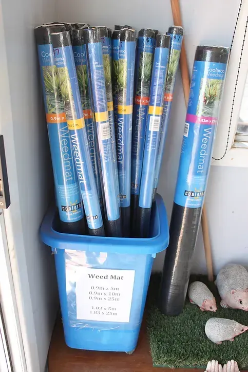 A Blue Bin Filled With Rolls of Weed Mat — Blue River Landscape Supplies in Foulden, QLD