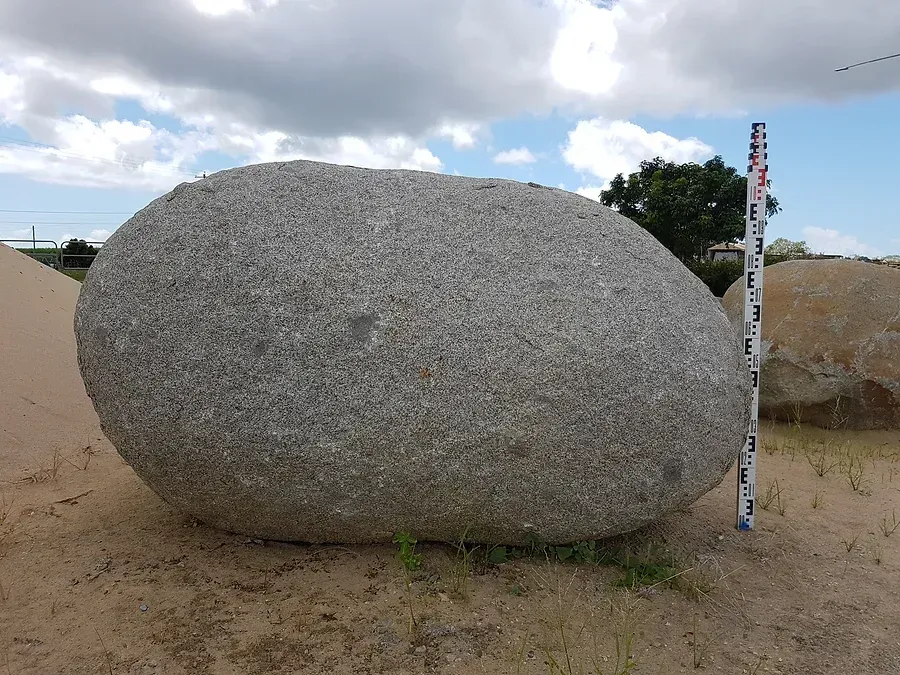 A Large Rock is Being Measured by a Pole — Blue River Landscape Supplies in Foulden, QLD