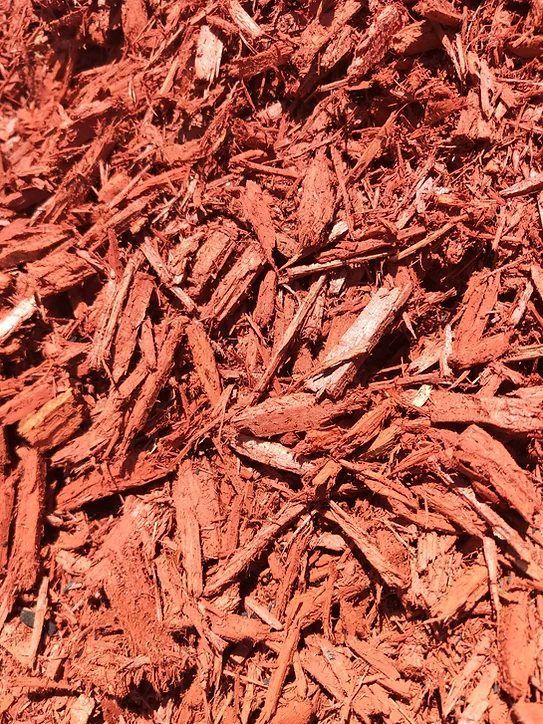 A Pile of Red Mulch is Sitting on the Ground — Blue River Landscape Supplies in Foulden, QLD