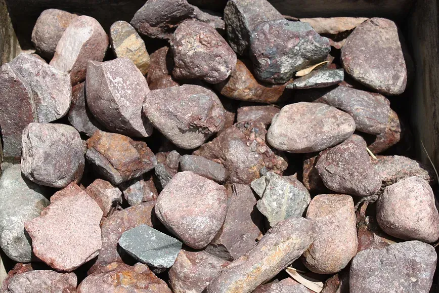 A Pile of Rocks is Sitting in a Wooden Box — Blue River Landscape Supplies in Foulden, QLD