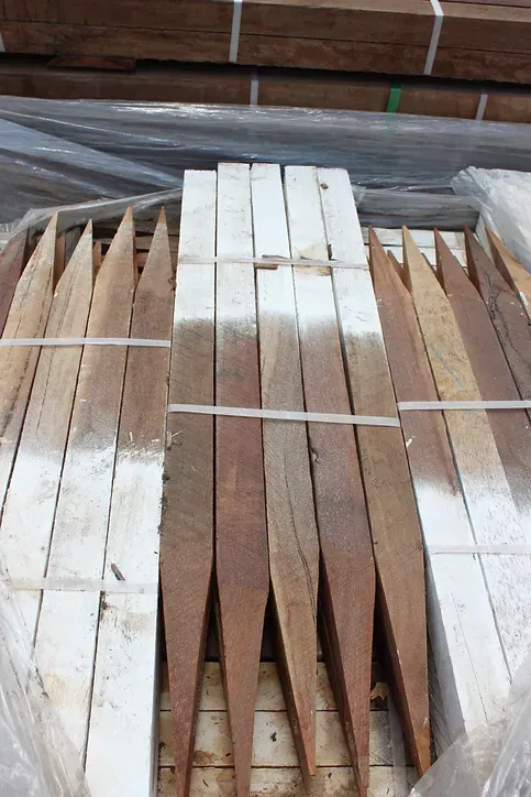 A Bunch of Wooden Sticks Stacked on Top of Each Other — Blue River Landscape Supplies in Foulden, QLD