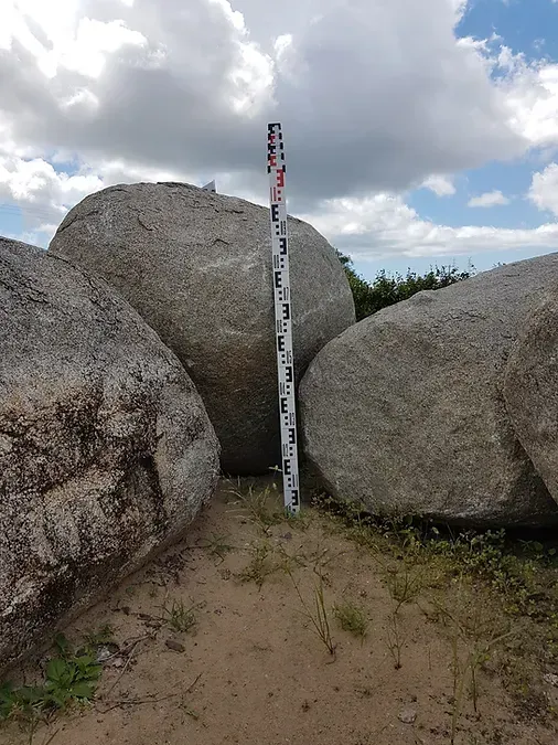A Measuring Stick is Standing in the Middle of a Pile of Rocks — Blue River Landscape Supplies in Foulden, QLD