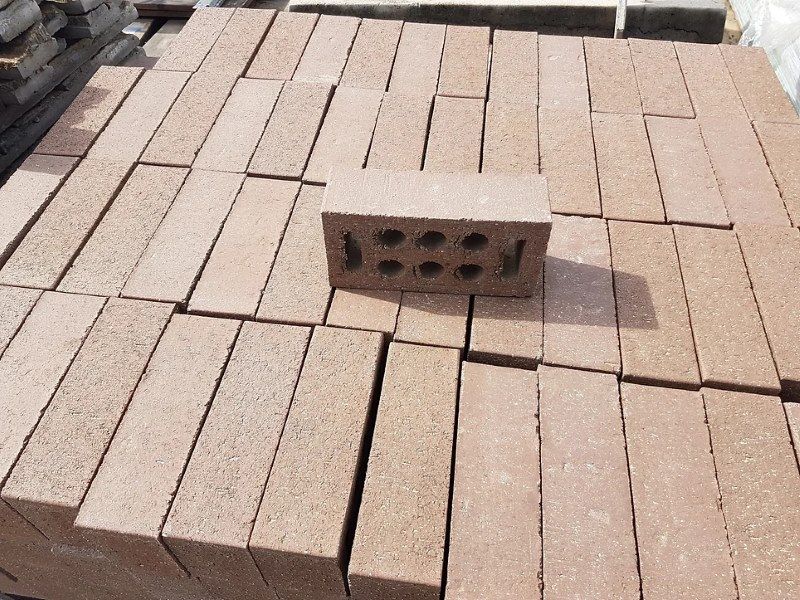 A Stack of Brown Bricks With a Brick Sitting on Top of Them — Blue River Landscape Supplies in Foulden, QLD