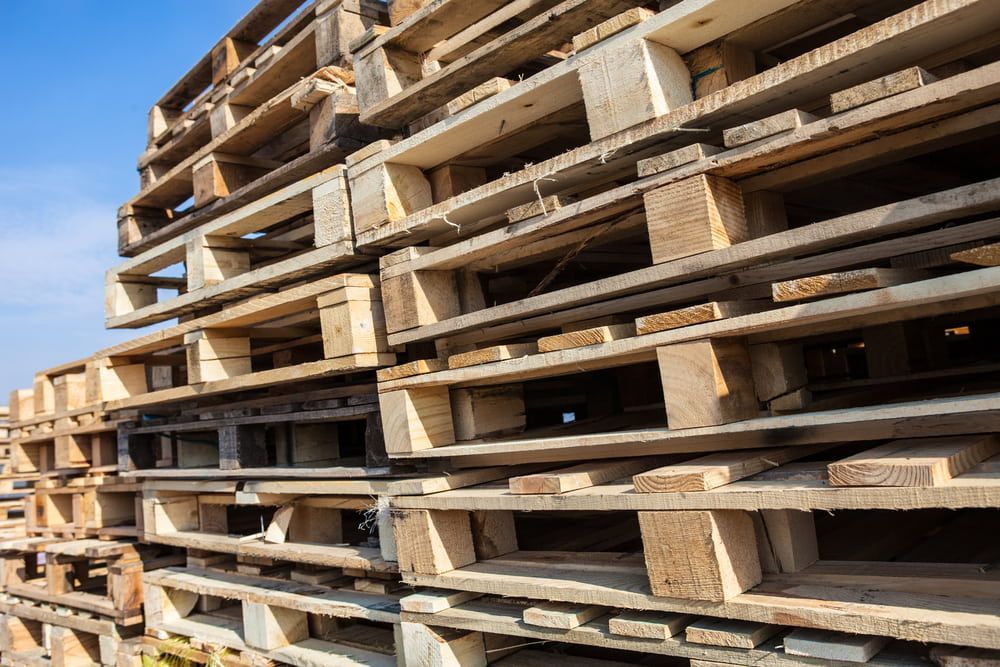 A Pile of Wooden Pallets Stacked on Top of Each Other — Blue River Landscape Supplies in Foulden, QLD