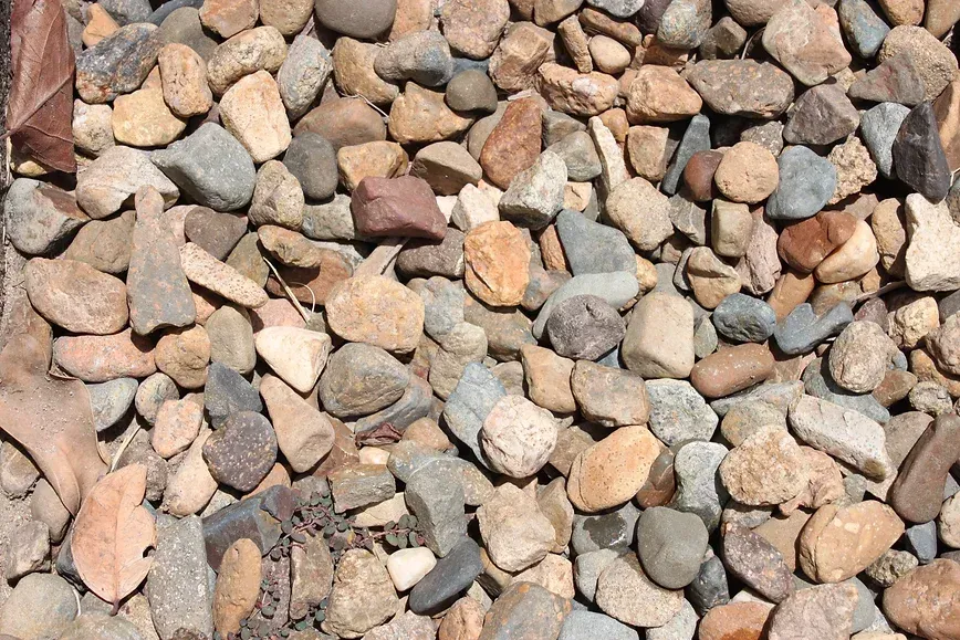 A Pile of River Rock Twenty mm is Sitting on the Ground — Blue River Landscape Supplies in Foulden, QLD
