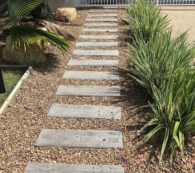 A Stone Walkway Surrounded by Plants and Rocks in a Garden — Blue River Landscape Supplies in Foulden, QLD
