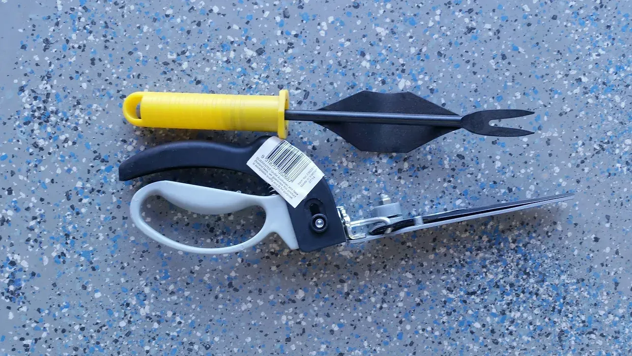 A Pair of Scissors and a Fork Are Sitting on a Concrete Surface — Blue River Landscape Supplies in Foulden, QLD