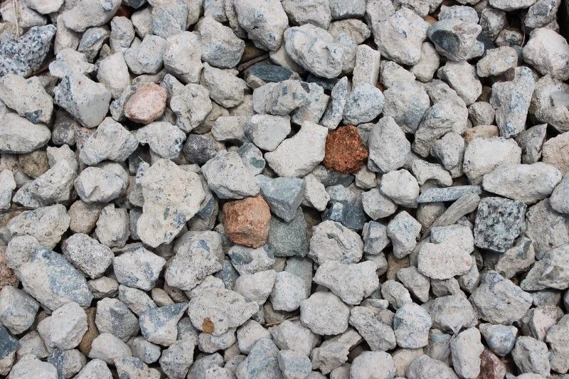 A Pile of Gravel With a Brown Rock in the Middle — Blue River Landscape Supplies in Foulden, QLD