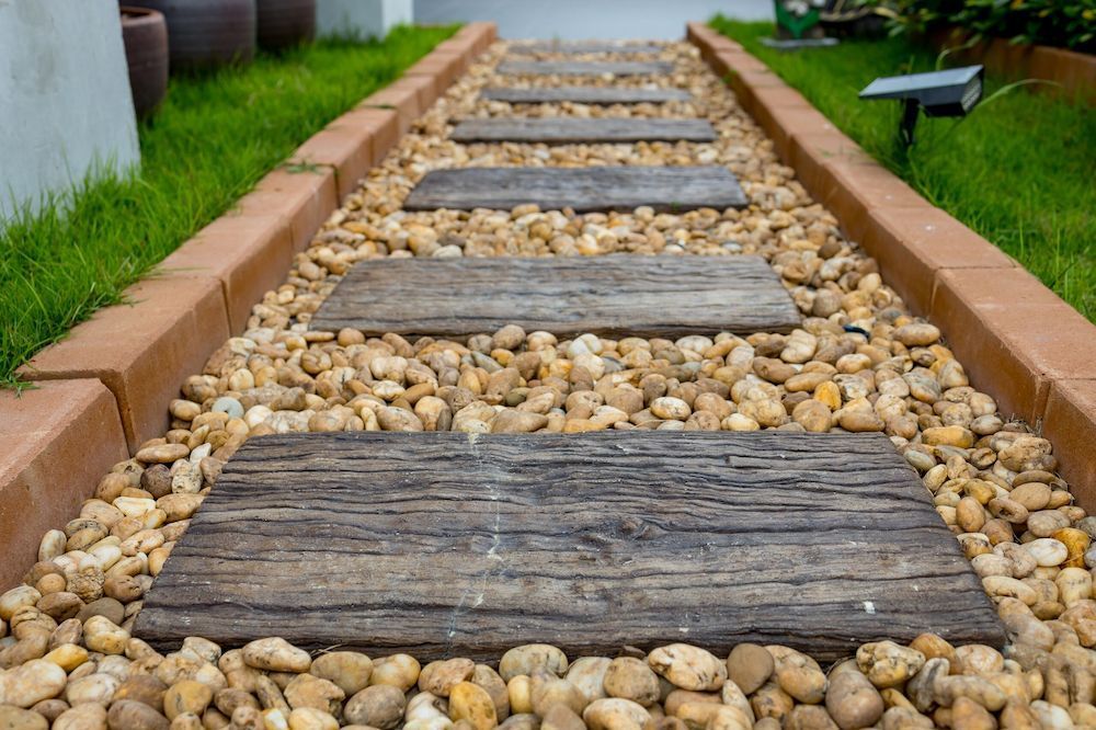 Pavers set in amongst stones on a pathway — Blue River Landscape Supplies in Foulden, QLD