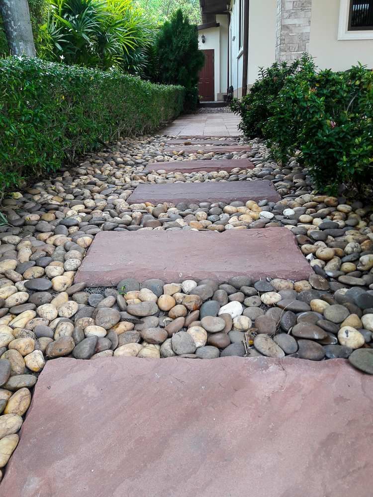 A Stone Walkway Leading to a House Surrounded by Rocks — Blue River Landscape Supplies in Foulden, QLD