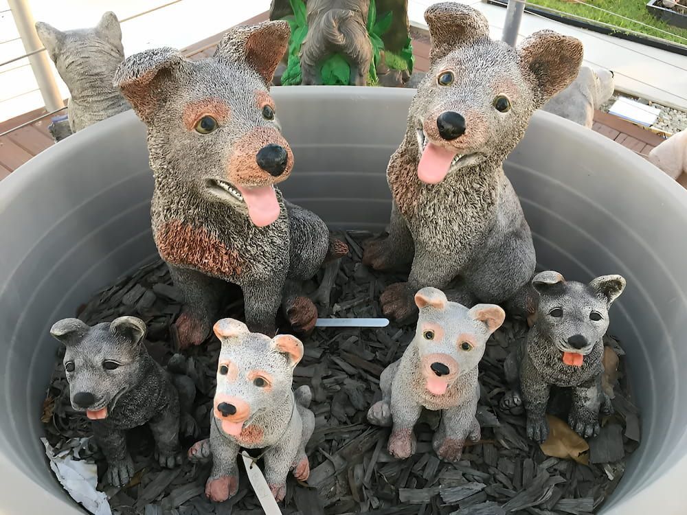 A Group of Statues of Dogs Are Sitting in a Pot — Blue River Landscape Supplies in Foulden, QLD