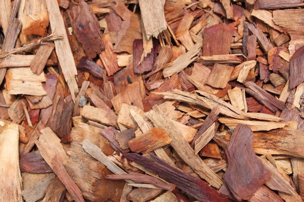 A Pile of Wood Chips is Sitting on the Ground  — Blue River Landscape Supplies in Foulden, QLD
