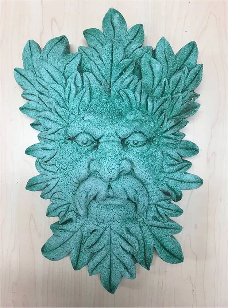 A Green Face With Leaves on It is Sitting on a Wooden Table — Blue River Landscape Supplies in Foulden, QLD