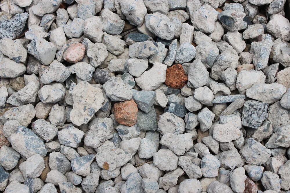 A Pile of Gravel With a Brown Rock in the Middle  — Blue River Landscape Supplies in Foulden, QLD