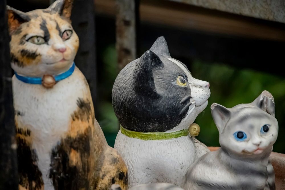 Three Statues of Cats Are Sitting Next to Each Other — Blue River Landscape Supplies in Foulden, QLD