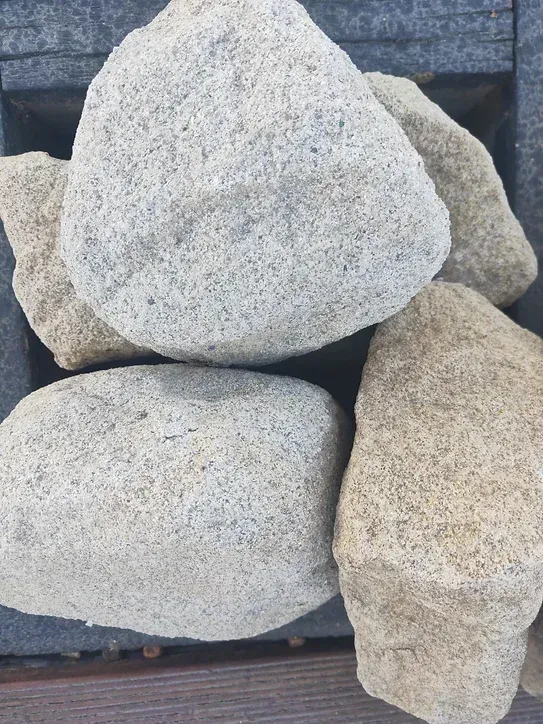 A Pile of Rocks Sitting on Top of Each Other on a Wooden Table — Blue River Landscape Supplies in Foulden, QLD