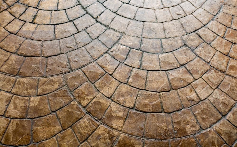 A Close Up of a Brick Floor With a Circular Pattern — Blue River Landscape Supplies in Foulden, QLD