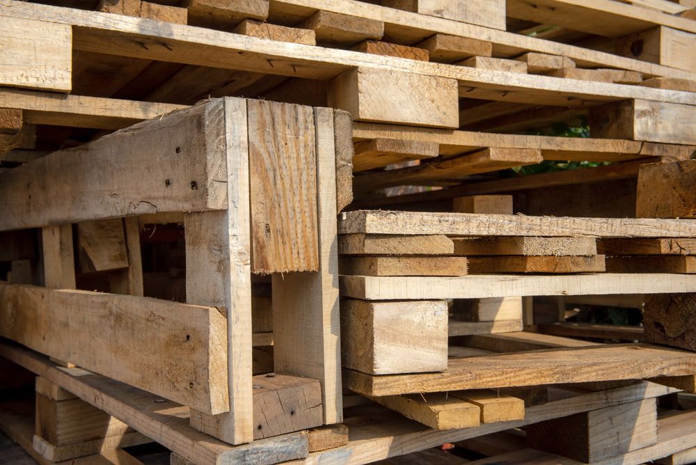 A Pile of Wooden Pallets Stacked on Top of Each Other — Blue River Landscape Supplies in Foulden, QLD