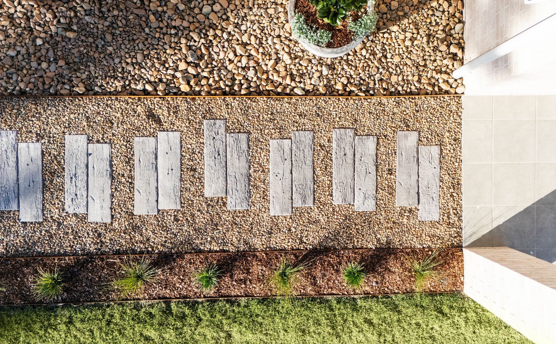A Drain is Sitting in the Middle of a Pile of Rocks — Blue River Landscape Supplies in Foulden, QLD