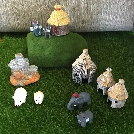 A Bunch of Figurines Are Sitting on Top of a Grass Covered Field — Blue River Landscape Supplies in Foulden, QLD