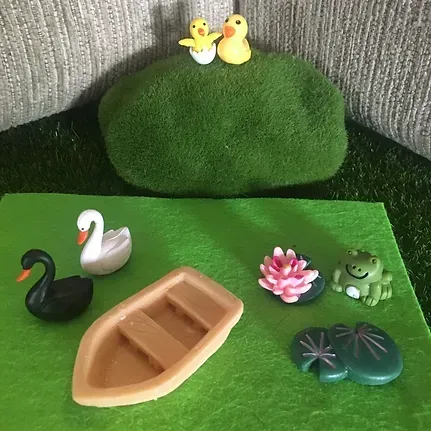A Swan , a Boat , a Frog , a Flower and Two Ducks Are on a Green Mat — Blue River Landscape Supplies in Foulden, QLD