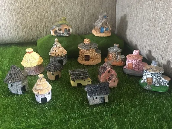 A Group of Miniature Houses Are Sitting on Top of a Pile of Moss — Blue River Landscape Supplies in Foulden, QLD