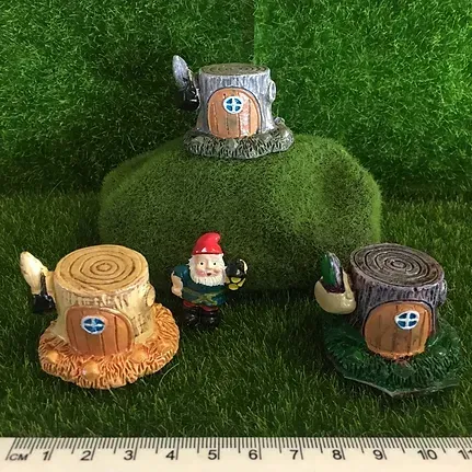 Three Gnomes Are Sitting on Top of a Pile of Moss Next to a Ruler — Blue River Landscape Supplies in Foulden, QLD