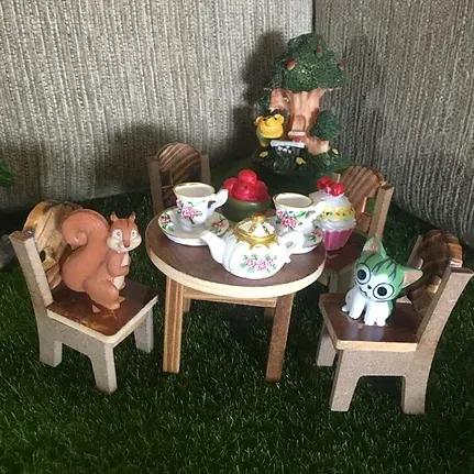 A Toy Tea Set With a Squirrel and a Cat Sitting at a Table — Blue River Landscape Supplies in Foulden, QLD