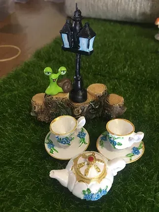 A Tea Set With a Teapot , Cups and Saucers on a Table — Blue River Landscape Supplies in Foulden, QLD