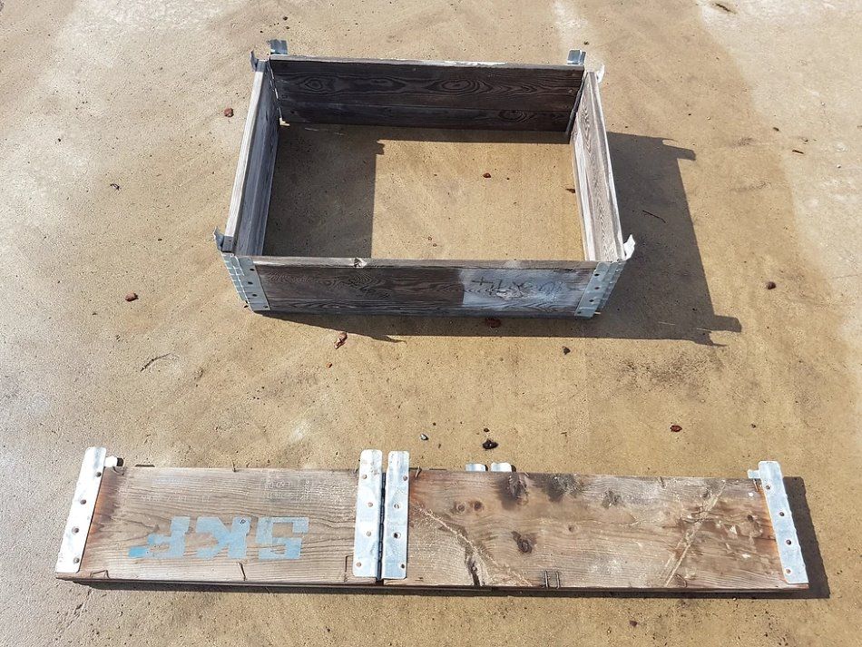 A Collapsible Wooden Garden Bed with the word skf written on it — Blue River Landscape Supplies in Foulden, QLD