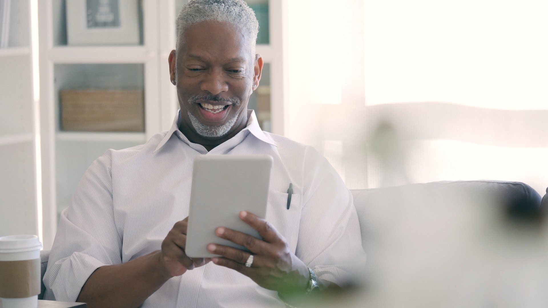 Smiling doctor looking at his smart tablet — Nationwide — Medical Management & Mentoring, LLC