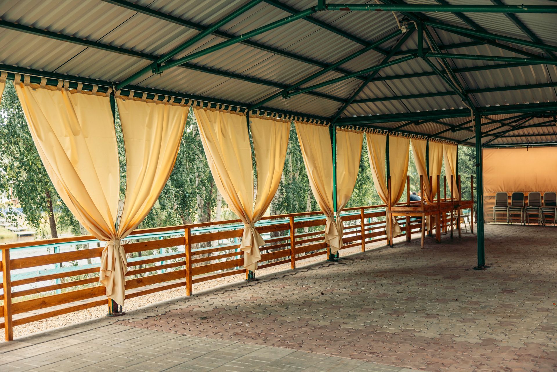 An empty outdoor area, covered from the sun by an event canopy.