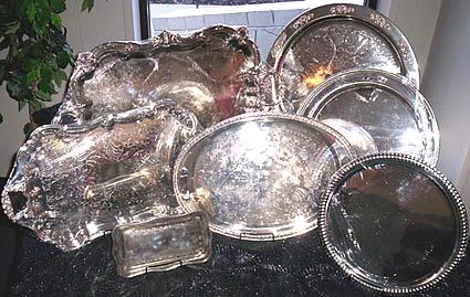 Silver serving trays and dishes on a table.