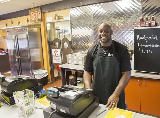 Grilled Barbecue — Man in Restaurant Counter in Elkhart, IN