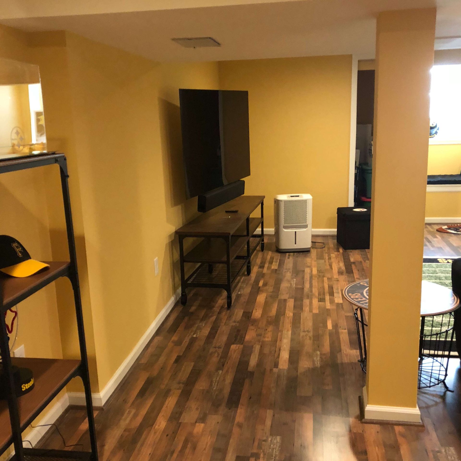 A living room with hardwood floors and yellow walls