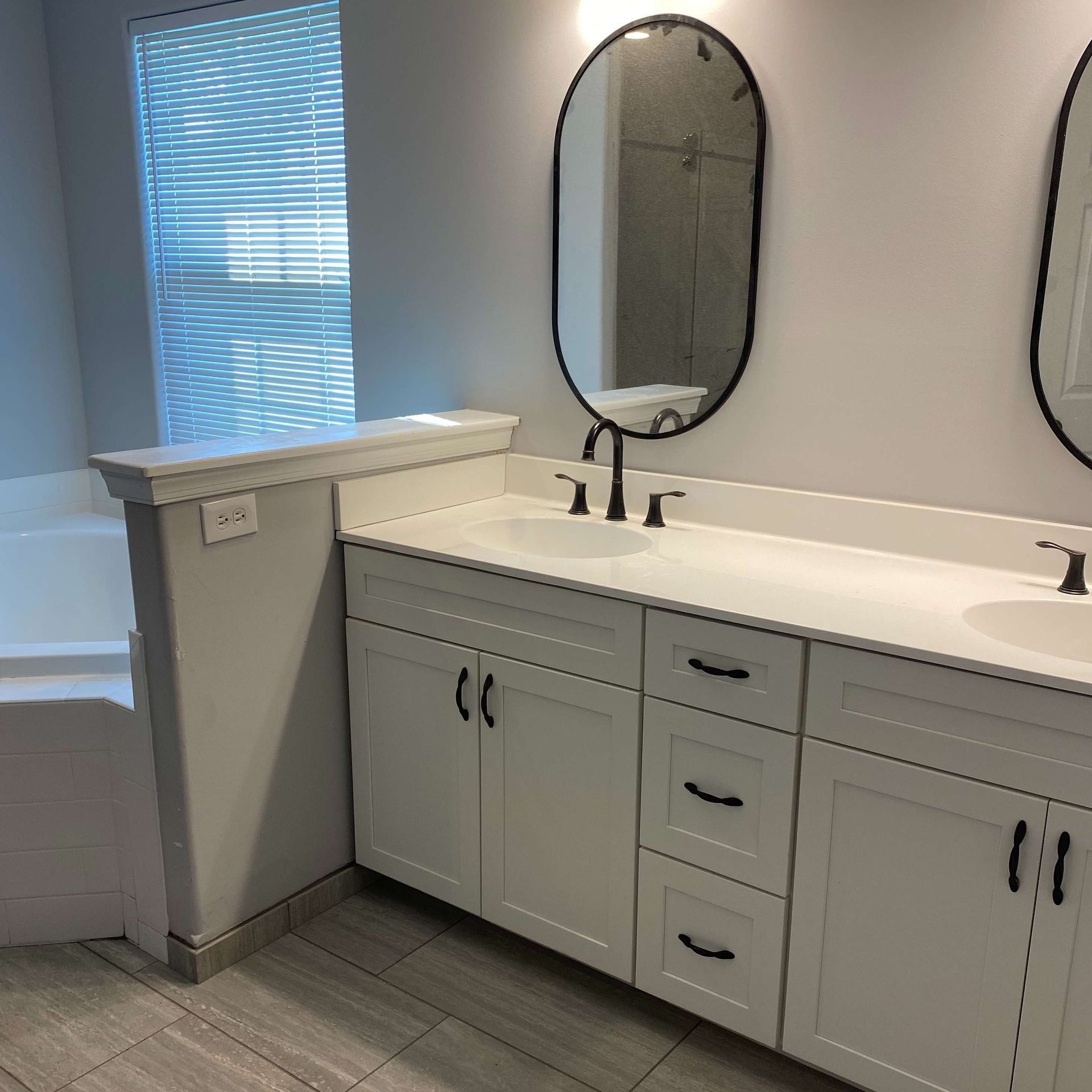 A bathroom with two sinks and two mirrors