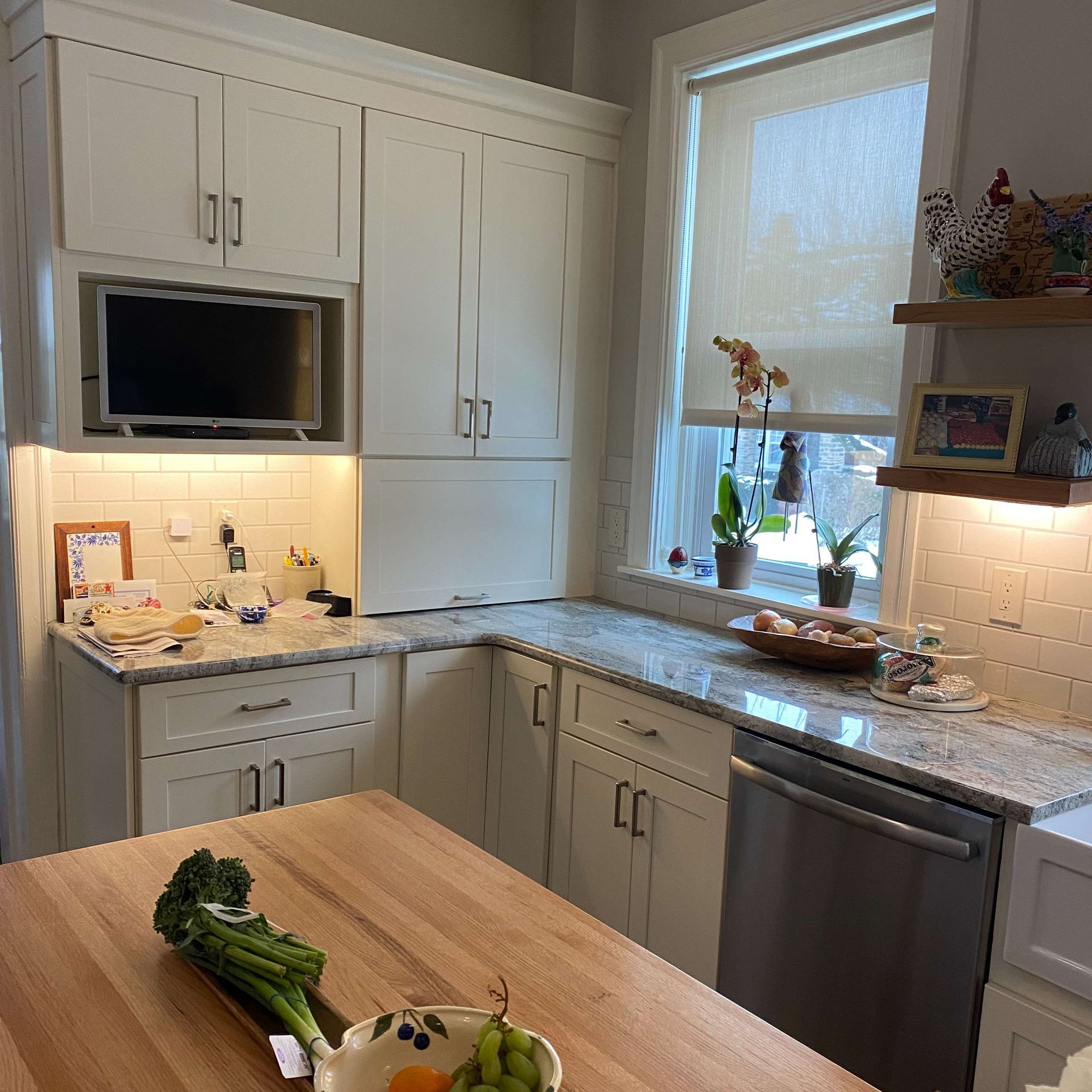 A kitchen with white cabinets and granite counter tops