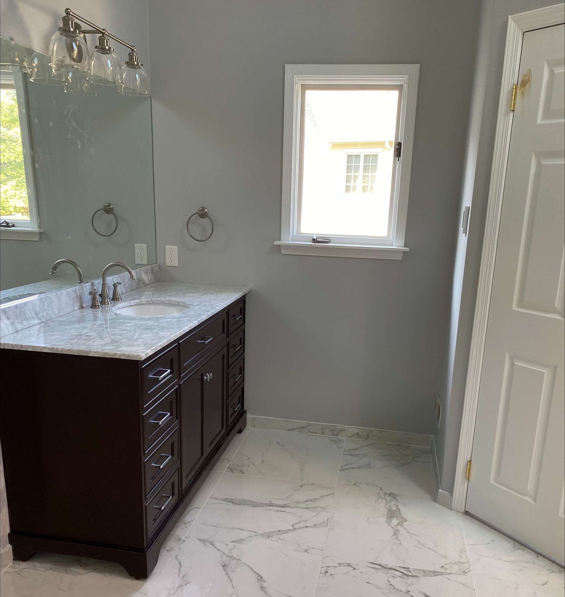 A bathroom with two sinks and a large mirror