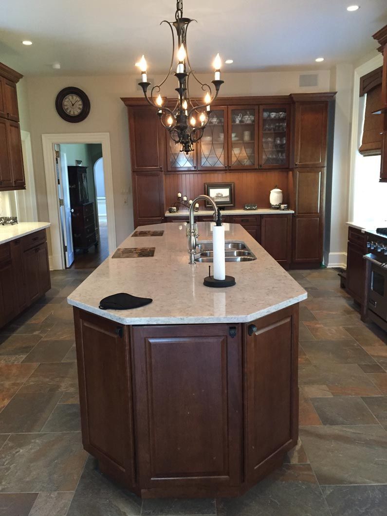 A kitchen with a large island in the middle