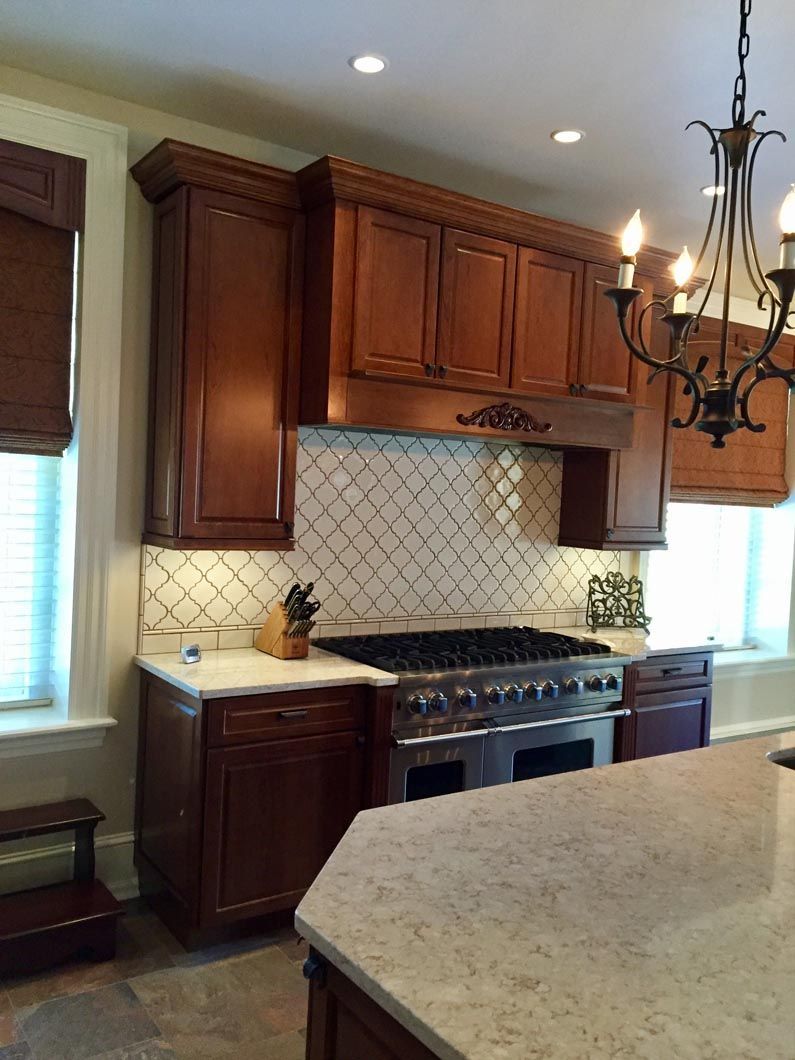 A kitchen with wooden cabinets and a stove top oven