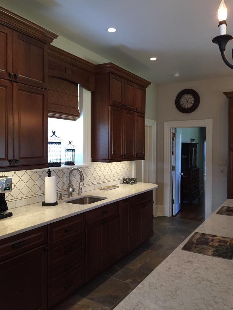 A kitchen with a sink and a clock on the wall