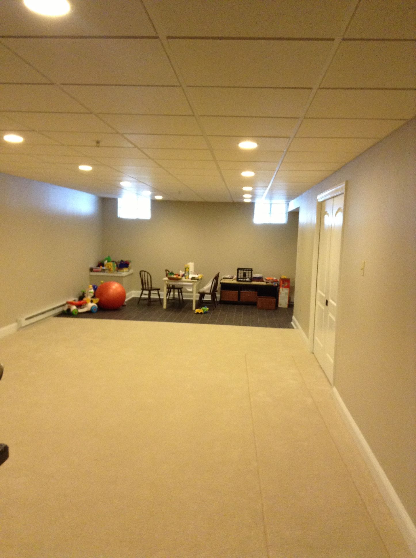 An empty basement with a table and chairs in it