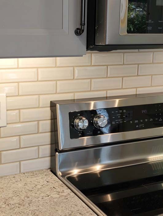 A stainless steel stove with a microwave above it