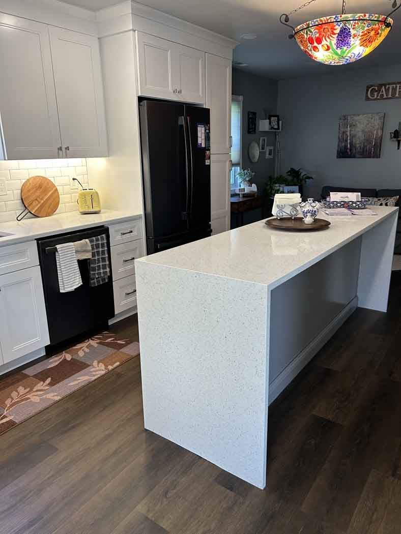 There is a large island in the middle of the kitchen.
