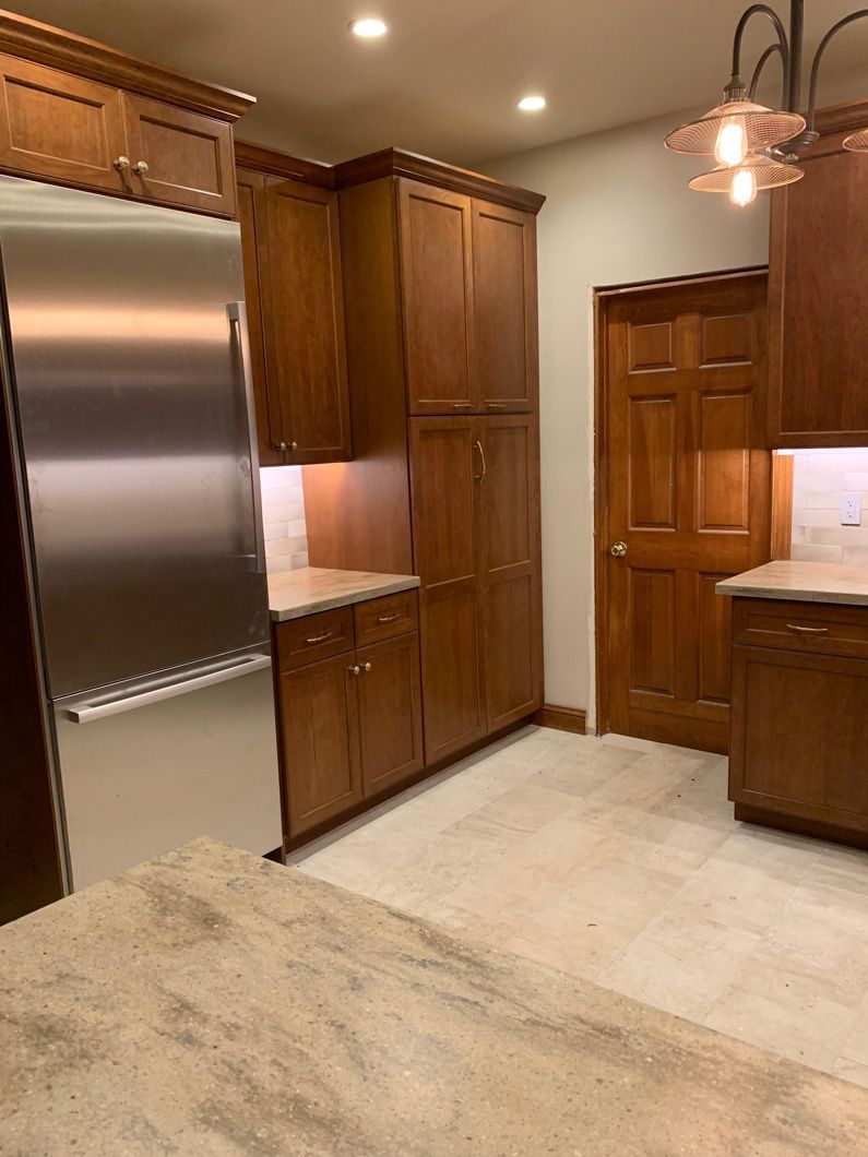A kitchen with wooden cabinets and stainless steel appliances.