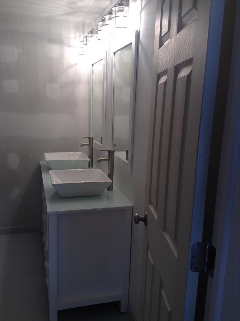 A bathroom with two sinks and two mirrors.