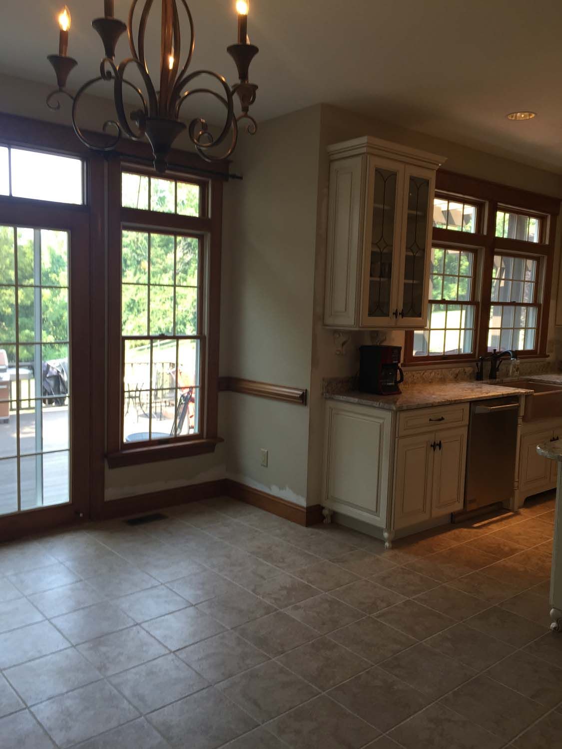 A kitchen with a lot of windows and a chandelier